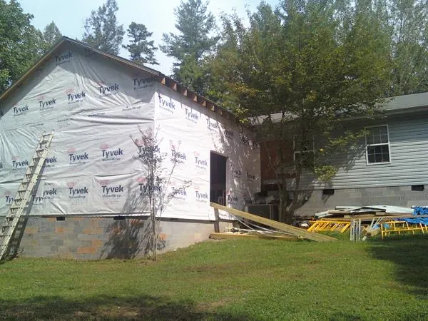 Tyvek wrapped gable on a new room addition beside an existing home in Baden
