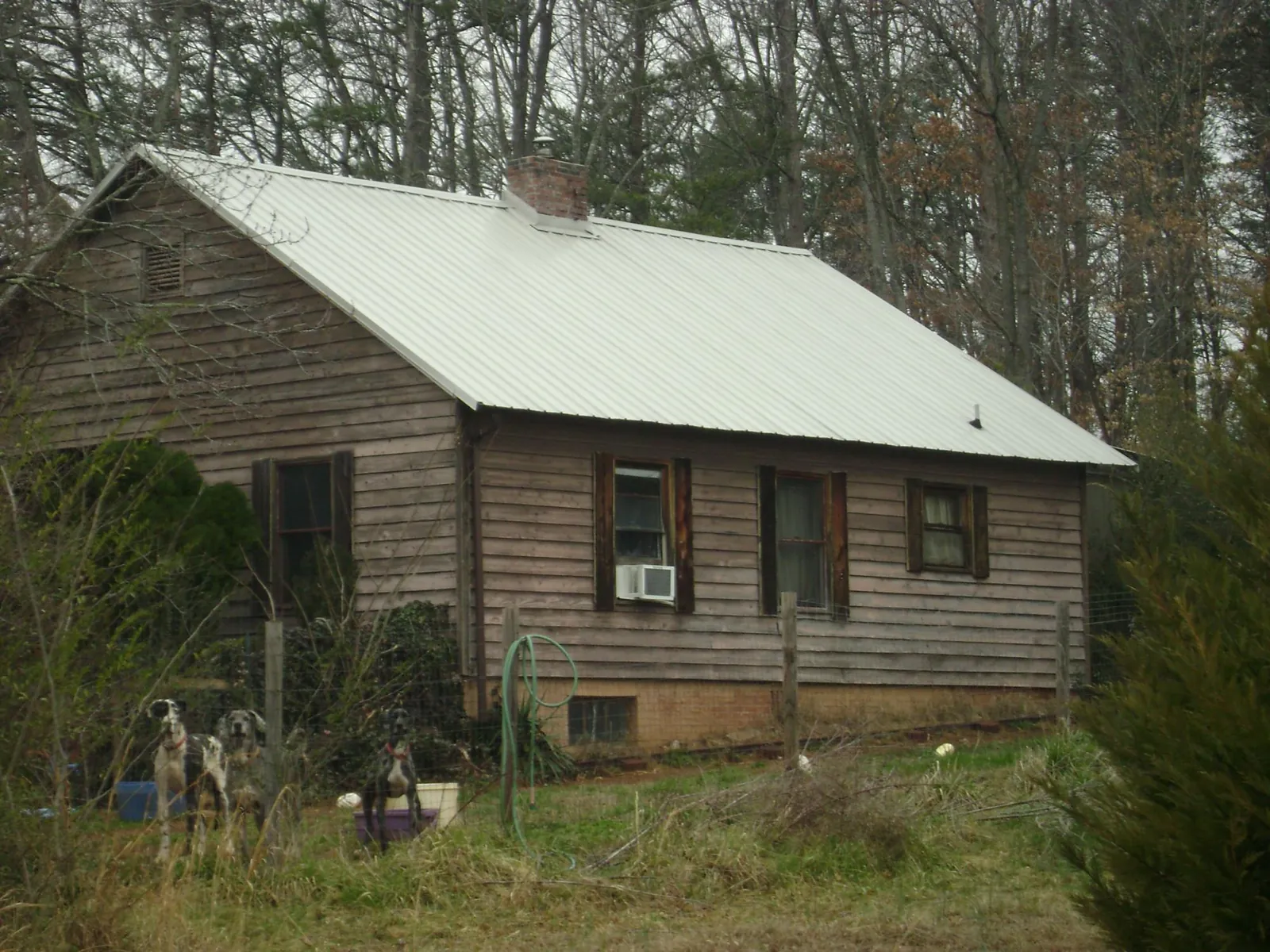 White metal roof on an old wood sided farmhouse, from a Metal Roof Installation job in Baden